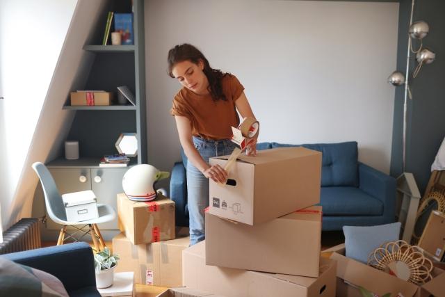 Woman packing boxes to move.