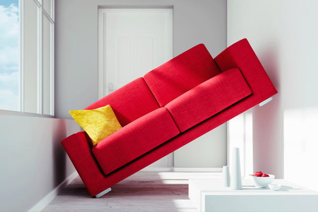 Red sofa stuck against walls