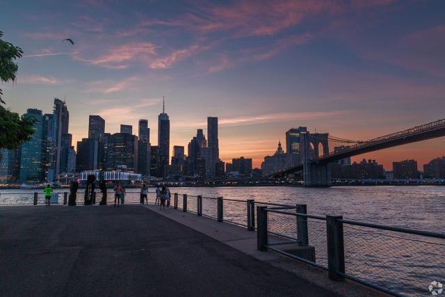 The New York City skyline is visible in Brooklyn. 