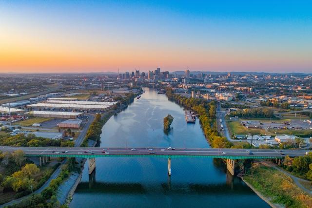 Nashville rises from where the river curves during sunset.