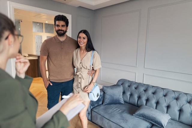 A couple touring a potential apartment.