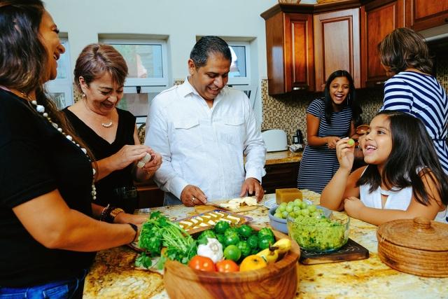 Multigenerational family cooking food in the kitchen.