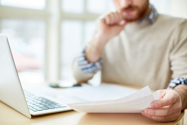 Man reading over a lease for an apartment.
