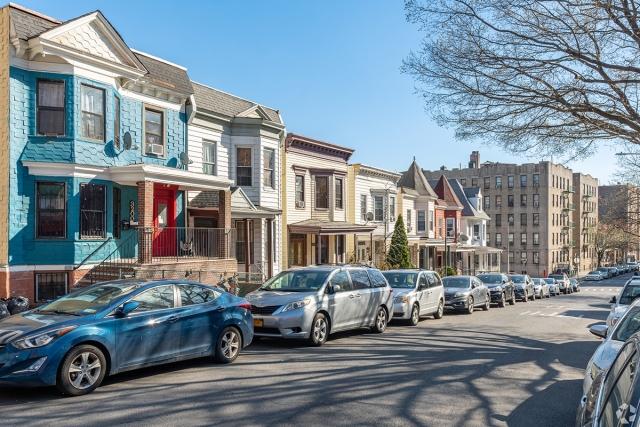 Cars parked along a residential street in the Bronx.