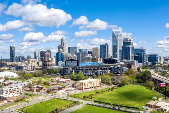 A view of skyscrapers in Uptown Charlotte with a park in the foreground.