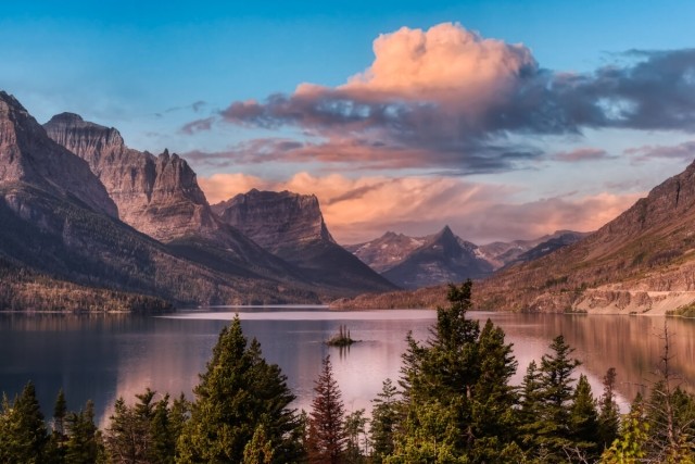 Sunset over a lake surrounded by mountains.