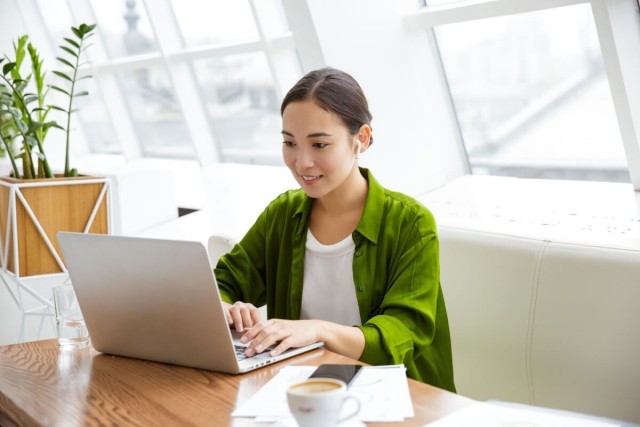 Lady sitting at desk looking at her computer