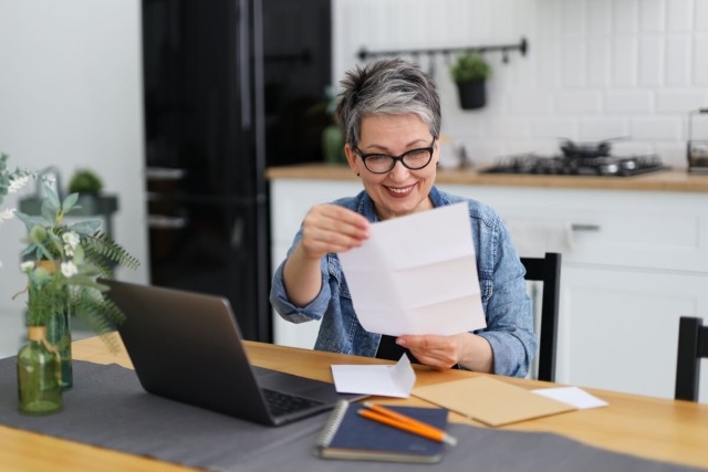 Renter opening mail to receive a security deposit refund check
