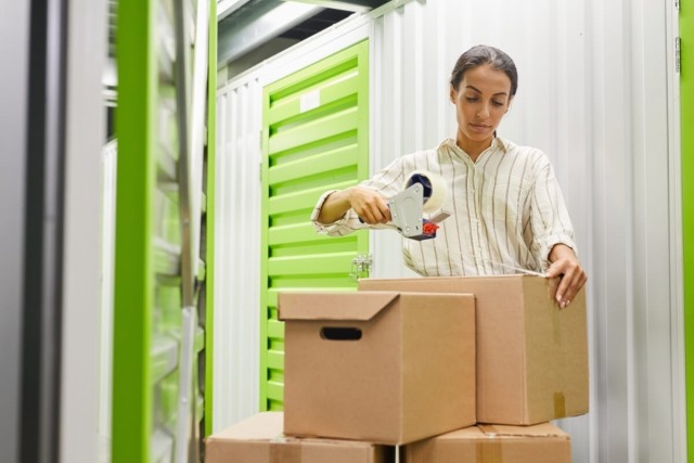 Tenant wraps up boxes to put in her apartment storage unit.