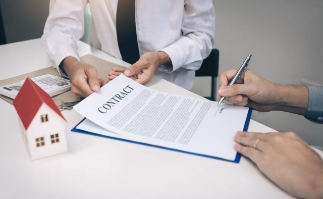 Renter signing a lease with a landlord