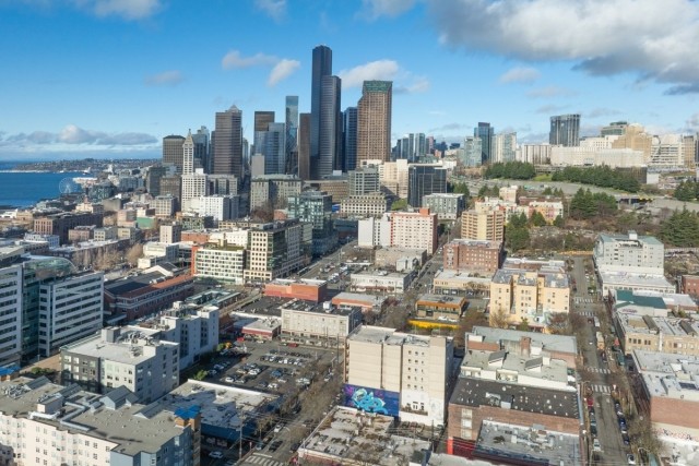 Downtown Seattle showcases historic apartment buildings mixed with modern skyscrapers and Elliott Bay waterfront, ideal for renters seeking urban charm and convenience. 