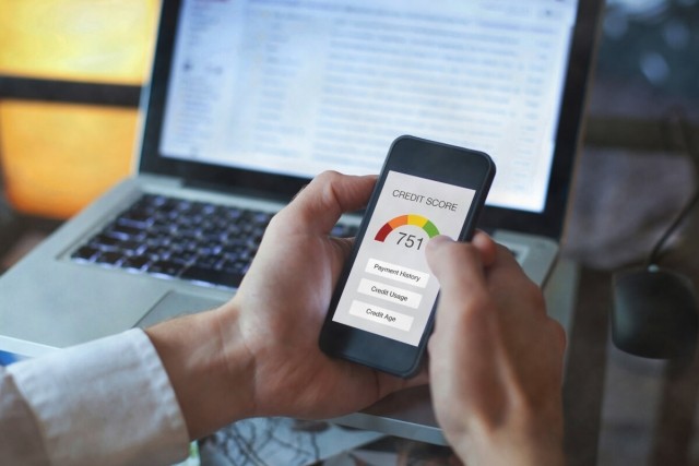A person looks at their 751 credit score on a smartphone.