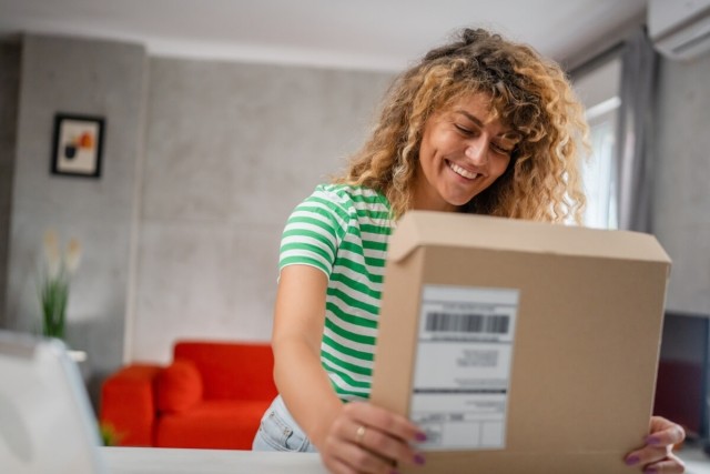 Renter opens a package in her apartment.