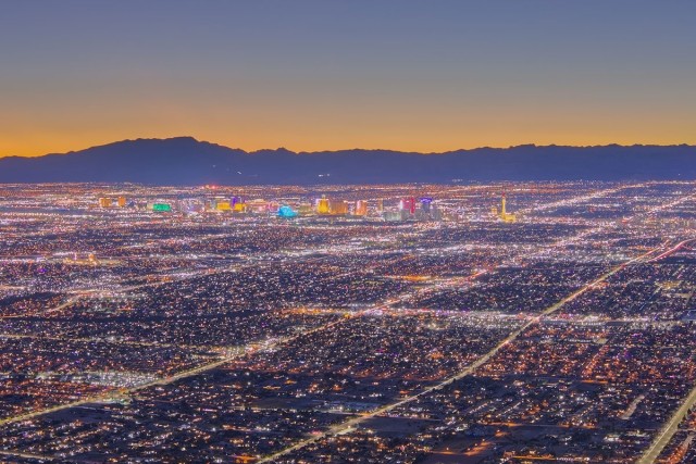 Las Vegas lights up at night with the Strip standing tall among the suburbs.