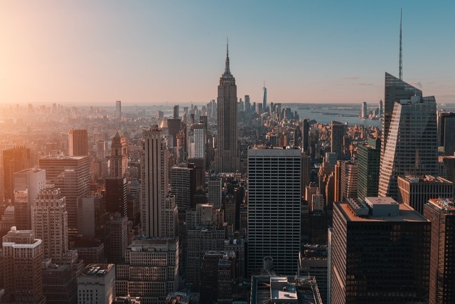The skyline of New York rises during the sunrise.