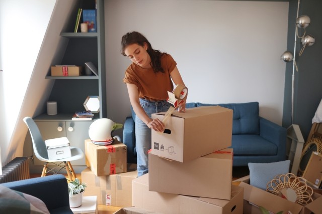 Woman packing boxes to move.