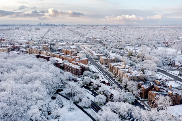 Suburbs of Detroit are covered in a blanket of snow with the city way in the background.