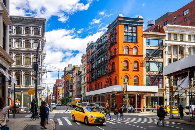 The streets of New York are full of people and cars.