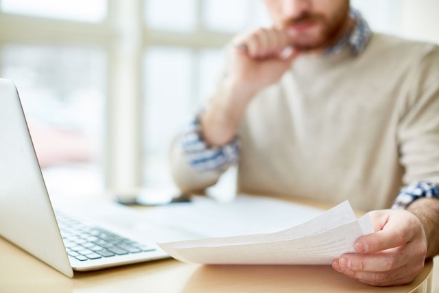 Man reading over a lease for an apartment.