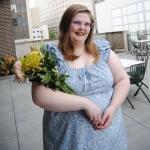 A professional image of Helen Ann Wells holding flowers. 