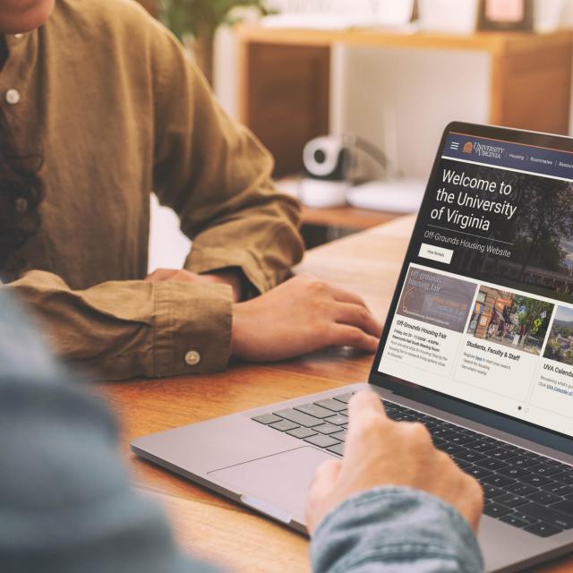 Two students using UVA off-grounds housing website