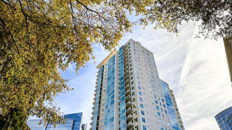 High-rise apartment building framed by fall colors