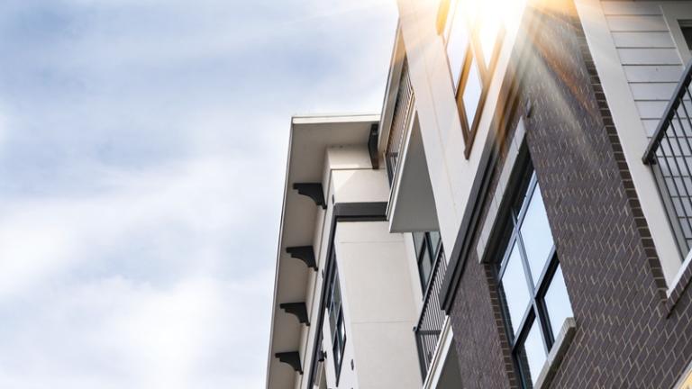 Low angle view of a mid-rise multifamily property against the sky