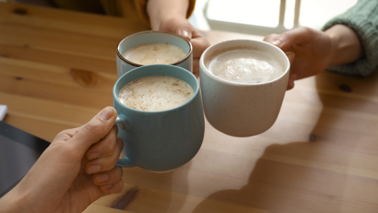 Clinking coffee mugs