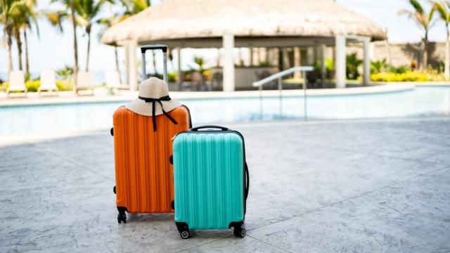 Two carry-on suitcases sitting at a vacation resort