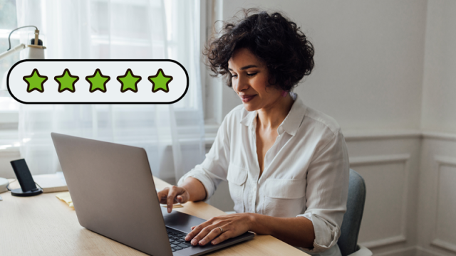 Woman typing a review on her laptop