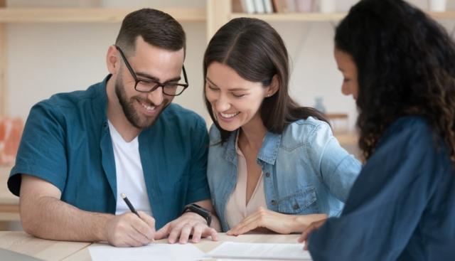 A young couple signs a lease with an independent landlord.