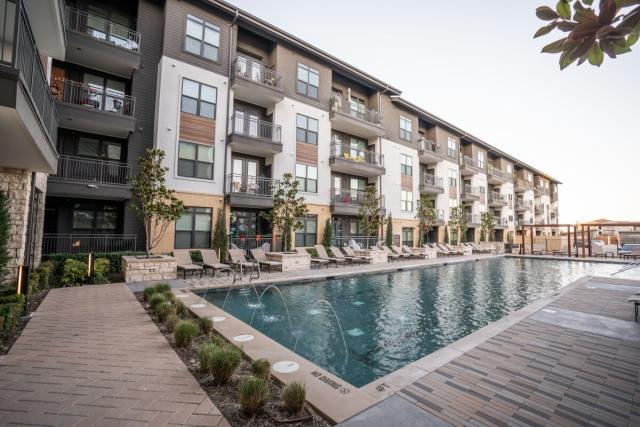Pool in front of luxury apartment building.