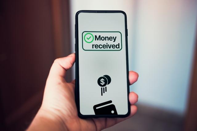 Person receiving money on their phone.