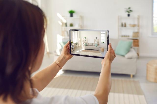 A landlord uses a tablet to capture a virtual tour of her rental property.