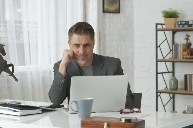 Man working in home office on rent roll.