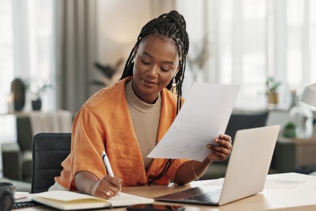 Young professional woman reviewing rent roll.