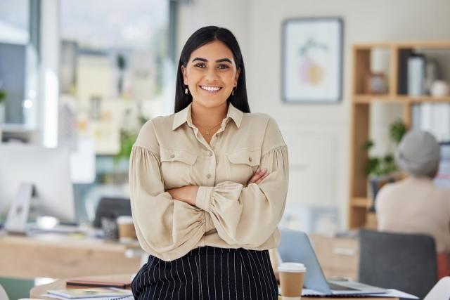 A landlord in office looking satisfied with her day