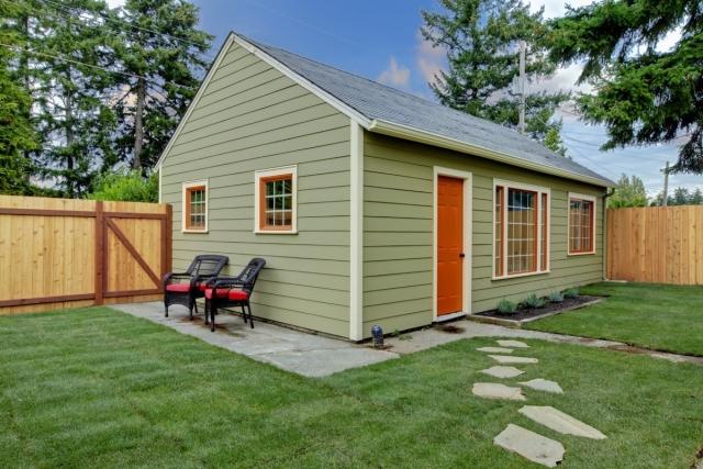 A small guest house with a yard and small patio