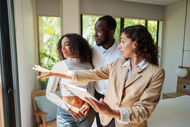 A landlord conducting a tour of a rental with a couple of prospective tenants
