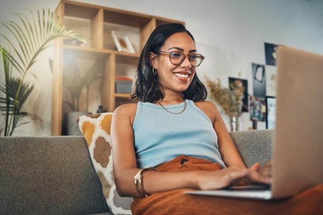 A smiling landlord using her laptop to market her rental property