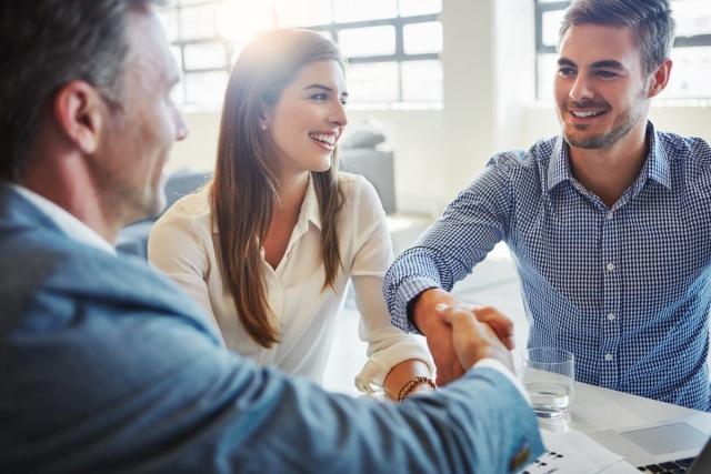 Couple meeting with landlord to sign a lease