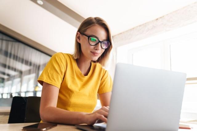 Person sitting at desk using a laptop 