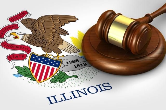 A gavel resting on top of the Illinois state seal