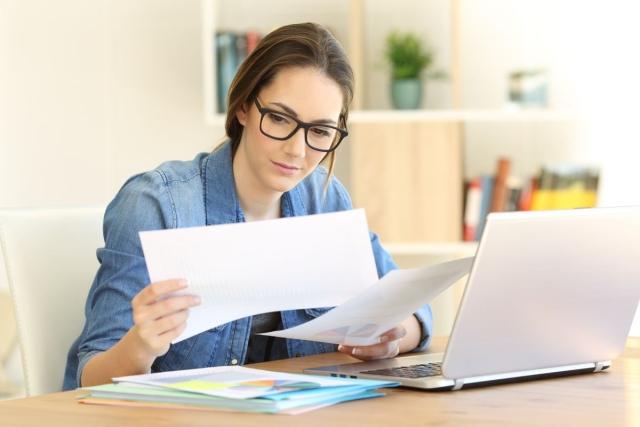 Business person reviewing paper documents