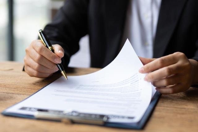 A business person sitting at a desk looking at a document