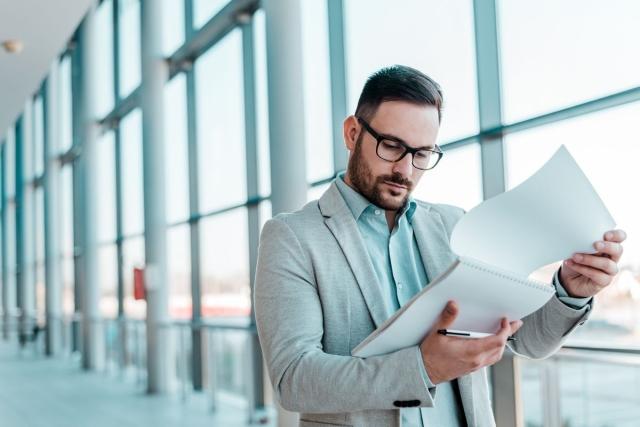 Man with glasses looking at documents