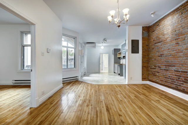 Vacant Apartment with Exposed Brick Backdrop
