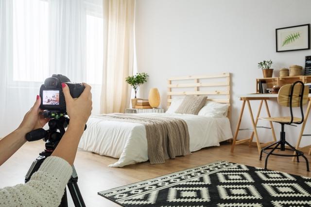 A landlord takes photos of a rental property with a professional camera.