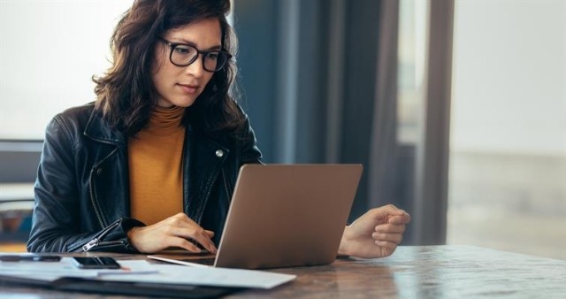 A woman staring at her laptop