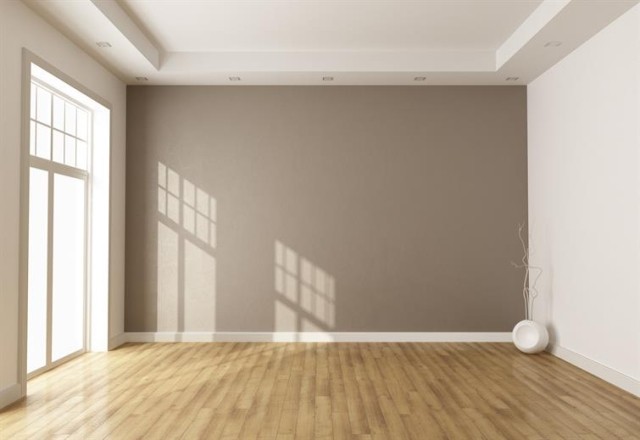 empty room with hardwood floors and an accent wall